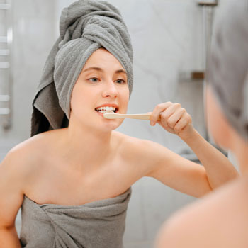 A young woman brushing her teeth