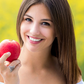 A woman holding an apple