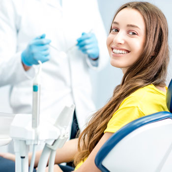 Smiling woman sitting on dental chair