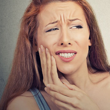 Woman with sensitive tooth ache problem