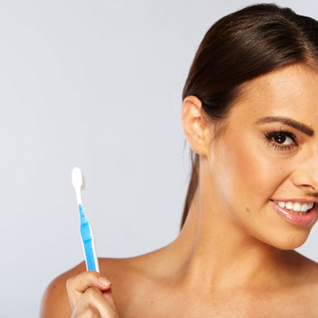 Woman holding tooth-brush