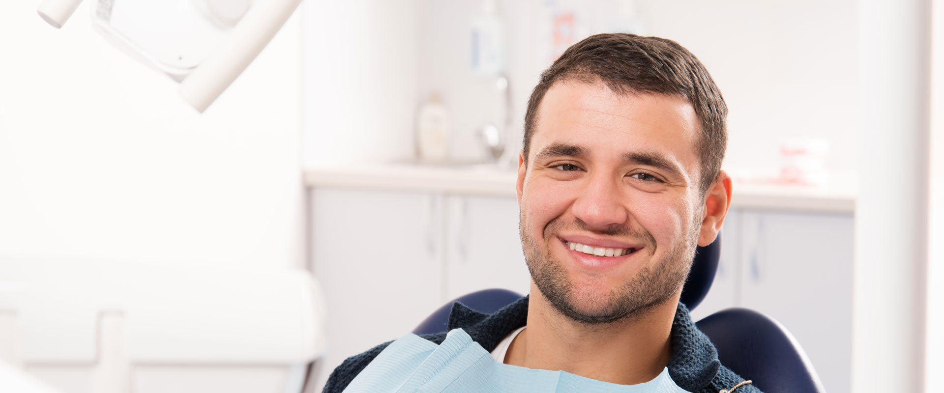 Smiling man sitting on dental chair